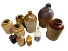 Quantity of earthenware flaggons, to include one marked Marsh, Spirit Merchant Bude, all as found