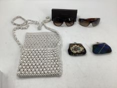 A pair of sunglasses, one marked Chanel, and one marked Karen Milan