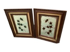 Pair of oak framed decorative wall mirrors with floral central decoration to glass