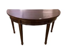 An Edwardian dark mahogany D-end/demi-lune side table in the Sheraton style