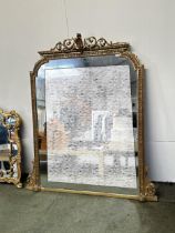A large gilt framed mirror, the top surmounted with scrolling and shell finial 171cm H x 151 Wide,