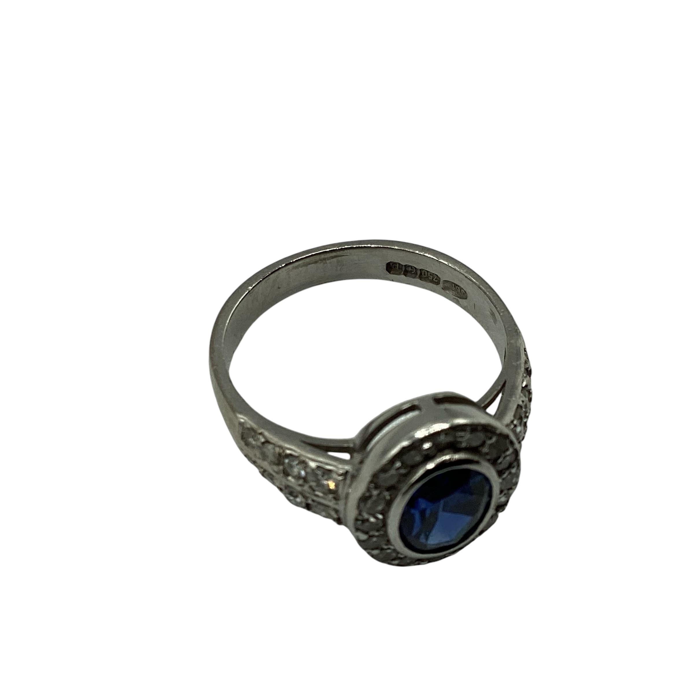 A 18ct white gold sapphire and diamond ring, central oval free cut sapphire in a rub over setting - Image 4 of 4