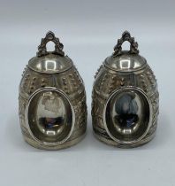 A pair of Chinese white metal ceremonial bells. Marks to base. 63,5g.