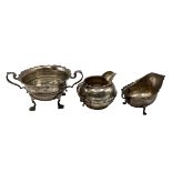Three sterling silver items, to include footed sugar bowl, cream jug and small sauce boat, various