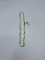 A strand of graduated cultured pearls on a 14ct gold clasp with matching ear studs. 40cm