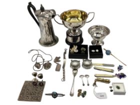 A collection of silver and white metal items