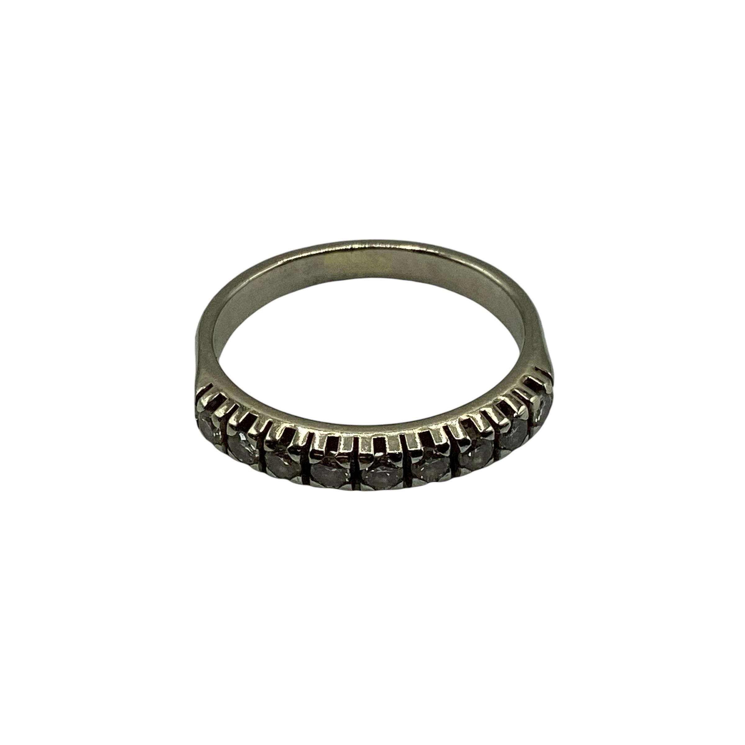 An 18ct white gold diamond set half eternity ring. Size J. 2.73g.