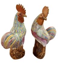 A pair of Oriental porcelain roosters with over glazed enamel feather decoration. Late Ching