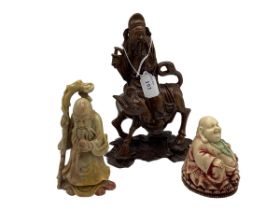 A collection of Oriental items to include a hard stone carving of an immortal a seated Buddha etc.