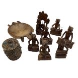 A quantity of Malaysian wooden figures, and a white metal lidded pot