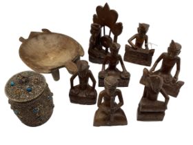 A quantity of Malaysian wooden figures, and a white metal lidded pot