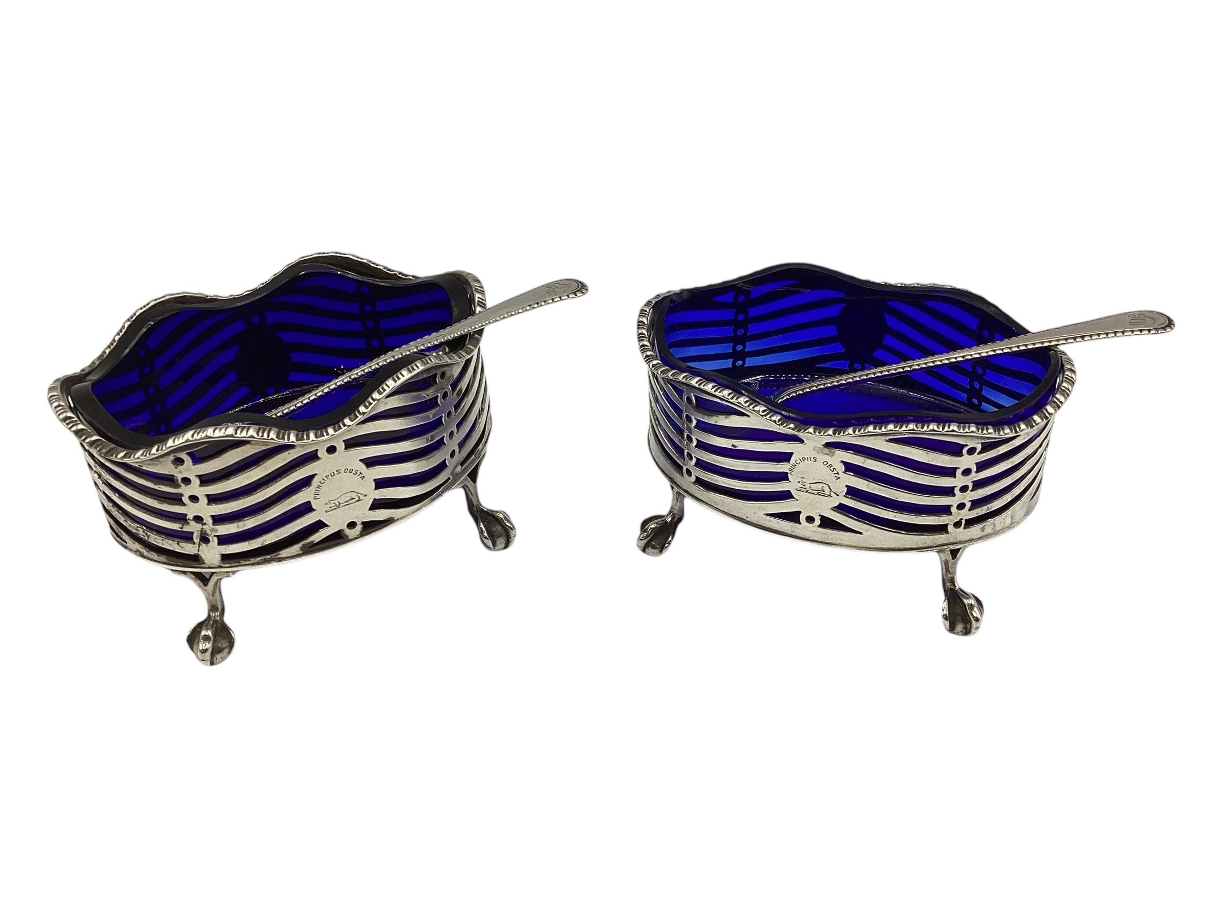 A pair of oval sterling silver salts with blue glass liners, GC London, George Chebsey, with