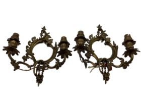 A pair of early C20th wall sconces with oval mirrors and foliate decoration, approx 31cm High
