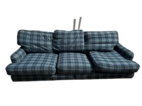 A three seater blue tartan upholstered sofa, and a blue upholstered foot stool (115cm x 77cm). 250