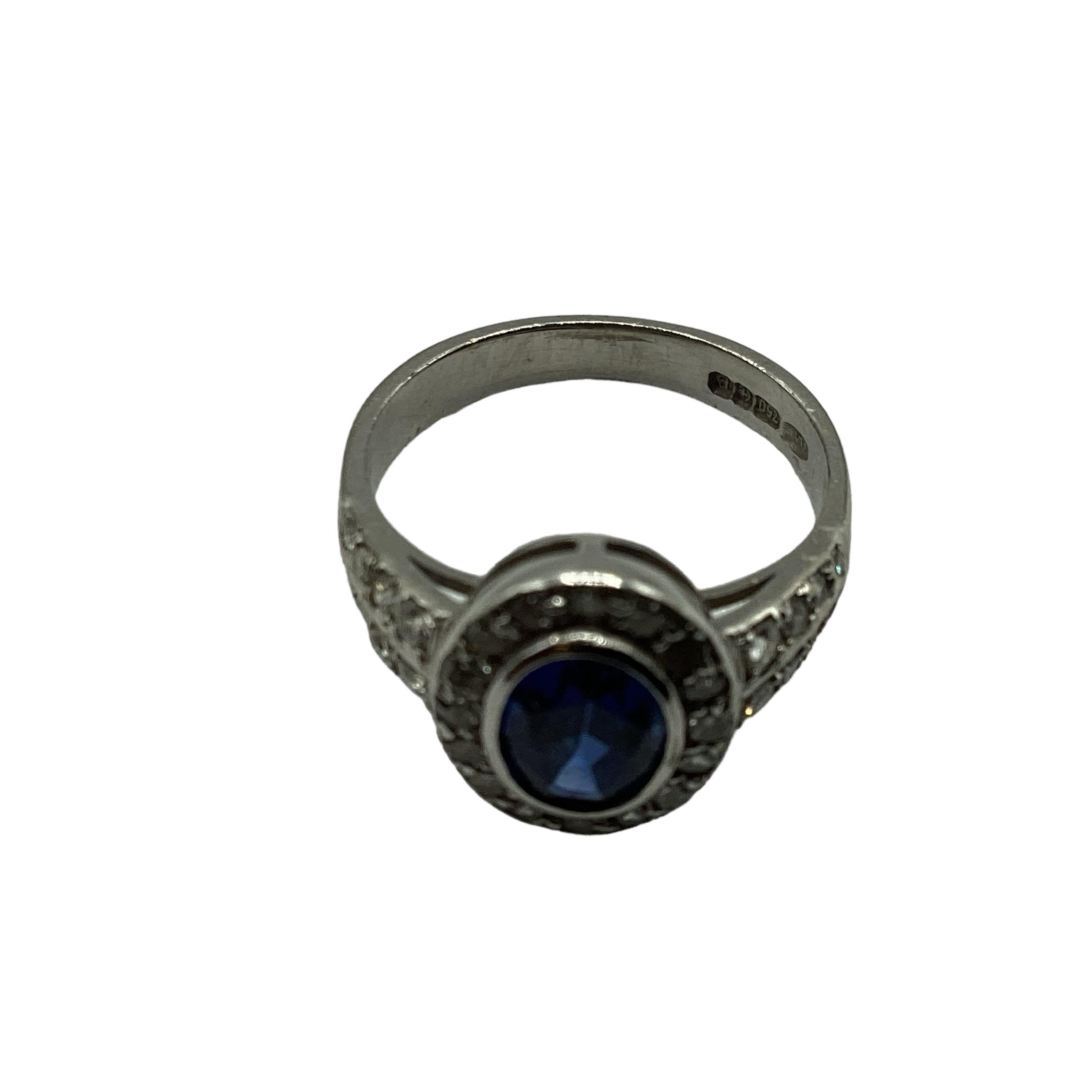 A 18ct white gold sapphire and diamond ring, central oval free cut sapphire in a rub over setting - Image 3 of 4