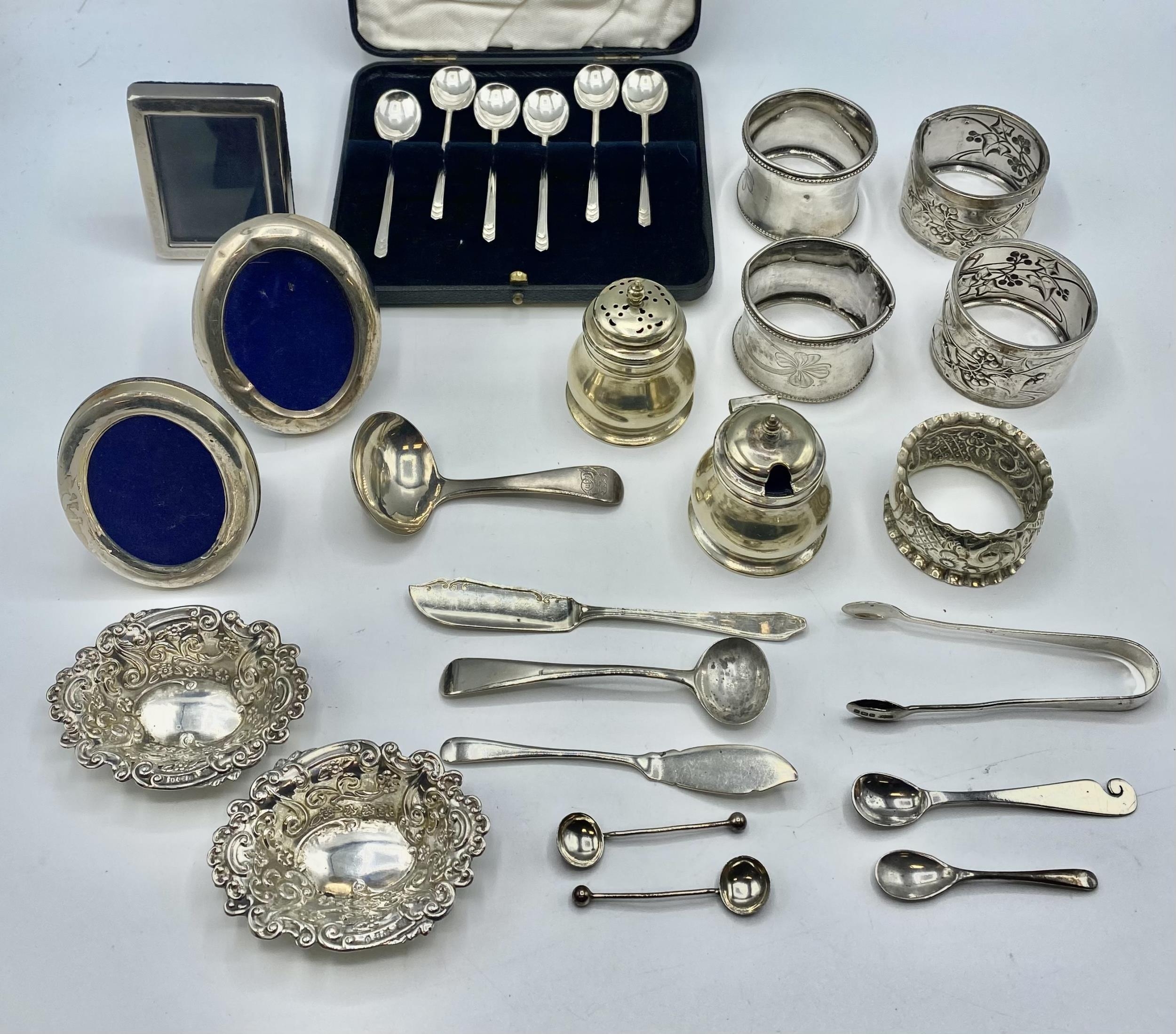A collection of sterling silver items to include napkin rings , picture frames condiments etc. Gross - Image 2 of 15