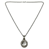 An 18ct white gold and diamond pendant in the Choppard style. Circular diamond set pendant with