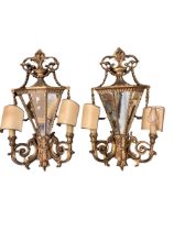 A pair of late C19th wall sconces, with mirrored backs and carved wooden gilded all over design,