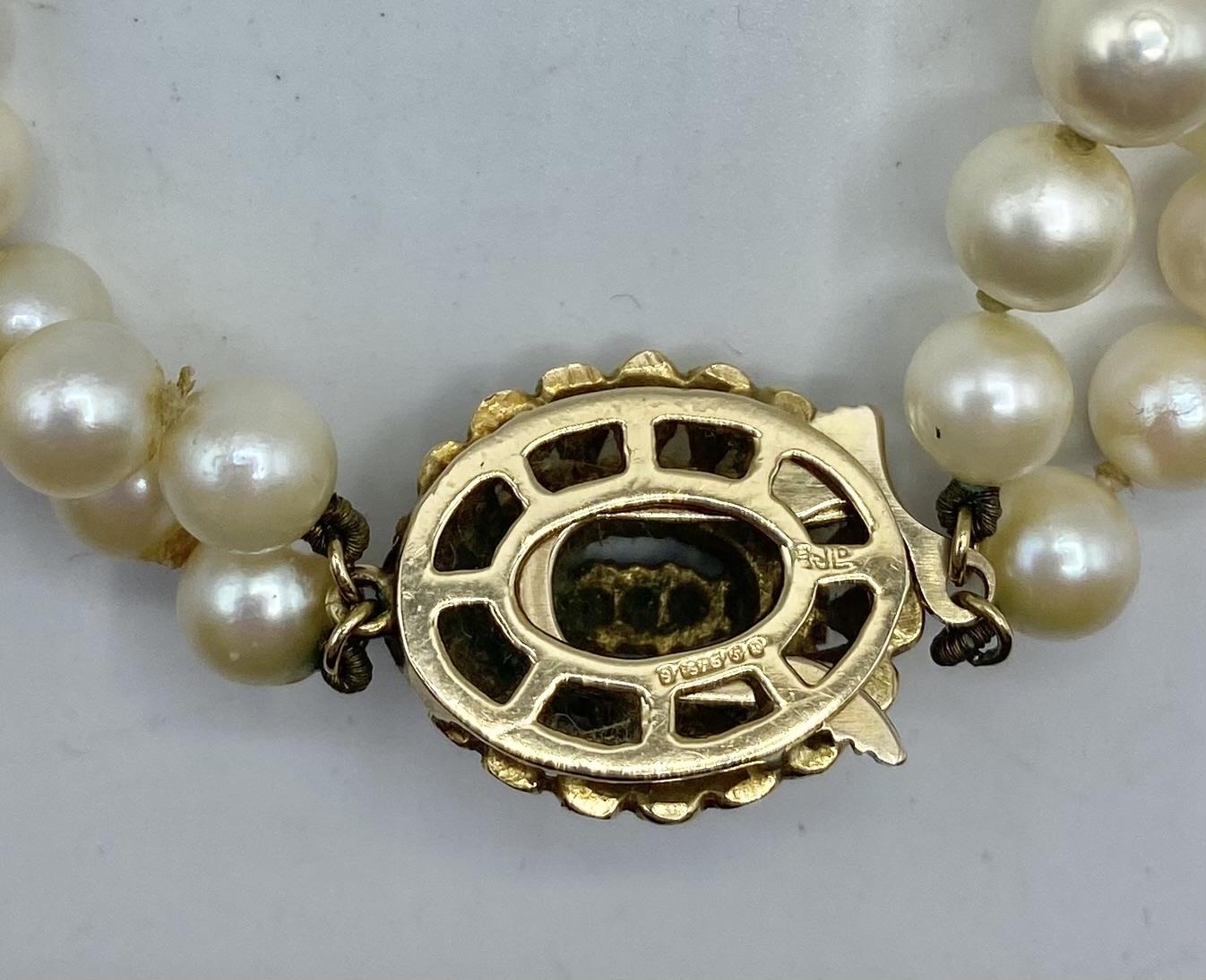 A double strand of graduated cultured pearls on a pearl set 9ct gold clasp. 48cm. - Image 3 of 3