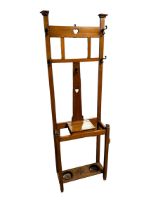 An Arts and Crafts hall stand, with mirrored and brass hooks and trip tray to base, 194cm H
