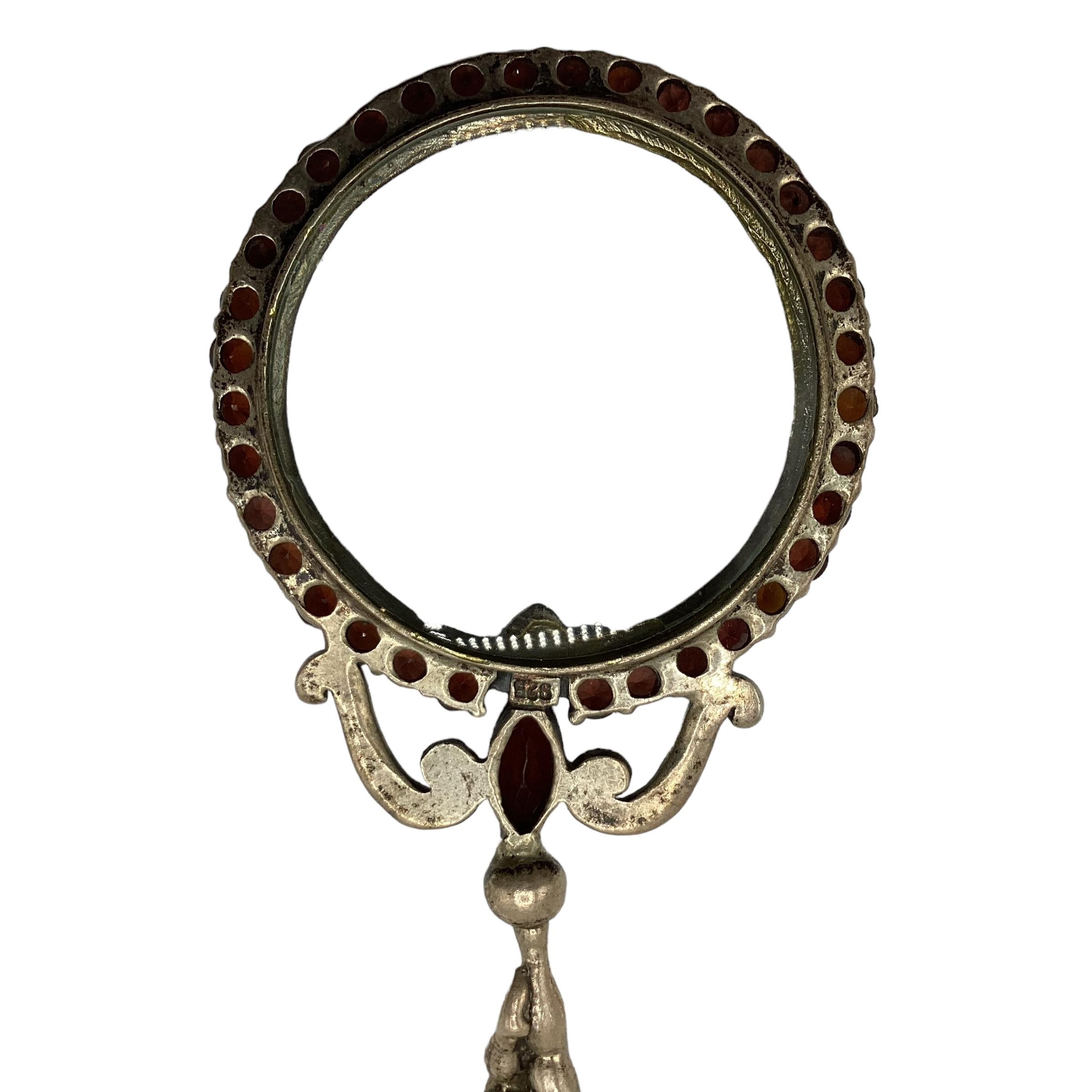 A 924 silver magnifying glass with cast putti handle and red garnet surround. - Image 2 of 4