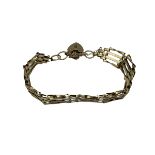 A 9ct gold gate link bracelet with 9ct gold heart locket, 10.3 g