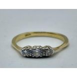 An 18ct gold and diamond three stone ring. 2.26g. Size O.