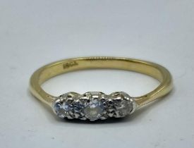 An 18ct gold and diamond three stone ring. 2.26g. Size O.