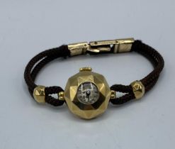 A Garrard and Co 18ct gold hexagonal domed cased ladies cocktail watch on cord strap.