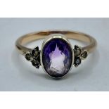 An unmarked yellow metal amethyst and pearl ring. 2.35g. Size M