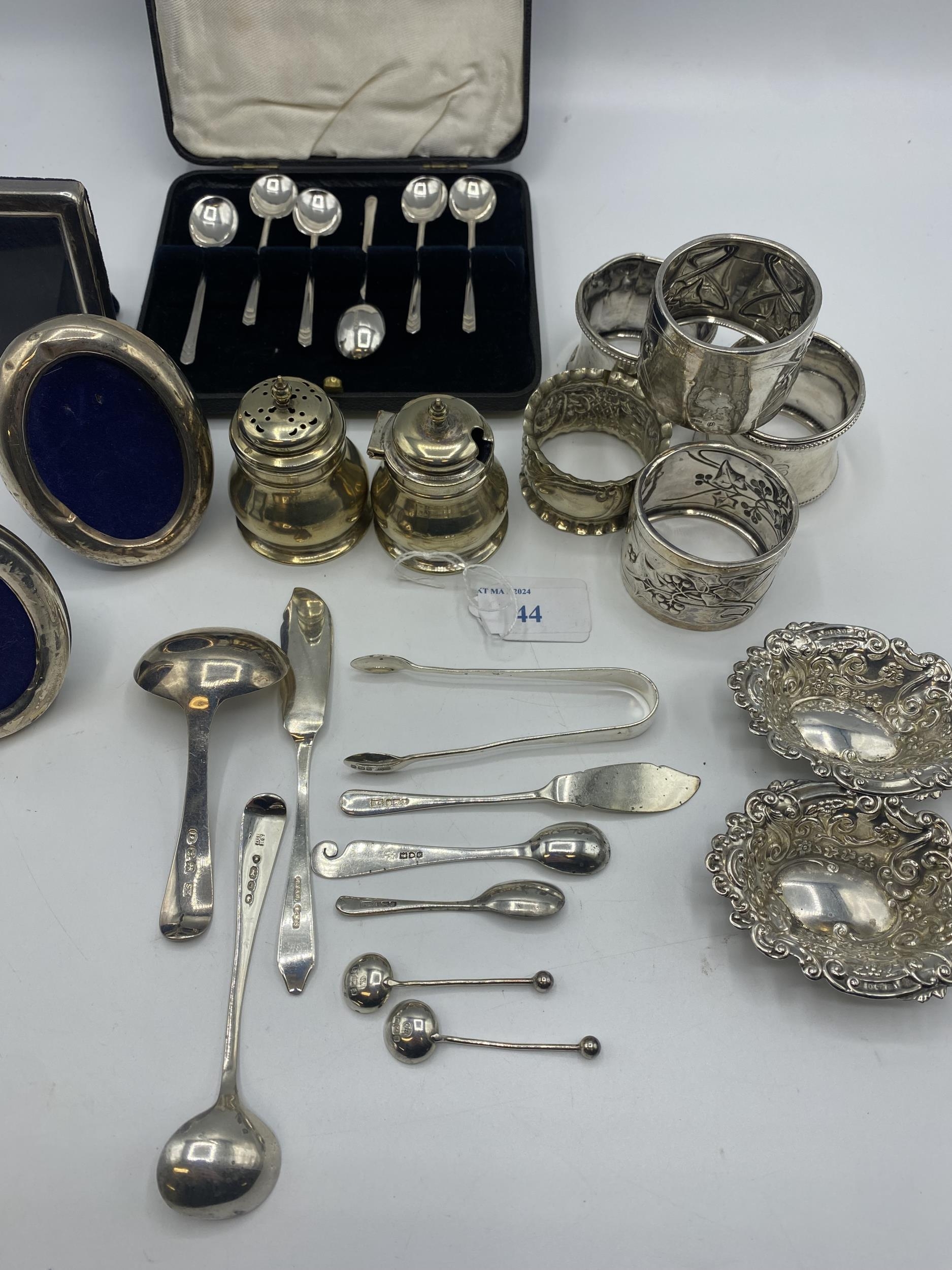 A collection of sterling silver items to include napkin rings , picture frames condiments etc. Gross - Image 14 of 15