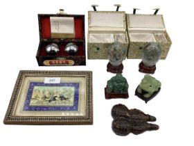 A collection of Oriental items to include a jade style Buddha, framed picture on panel, stress balls