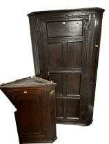 A small oak hanging corner cabinet 97cmH x 80cmW x 46cmD, and a tall oak panelled corner cupboard