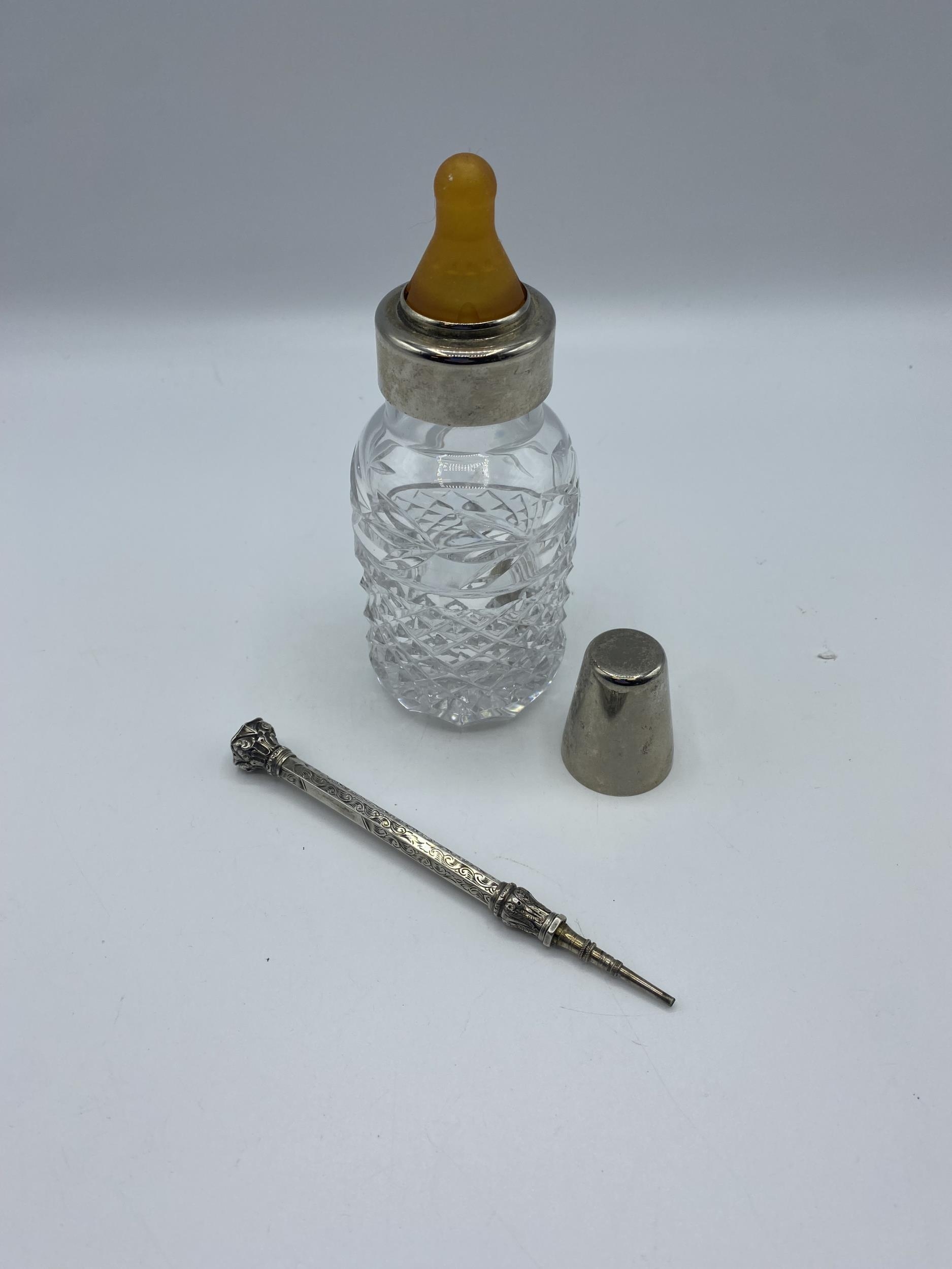 A cut glass and white metal baby bottle together with a white metal propelling pencil with - Image 2 of 5