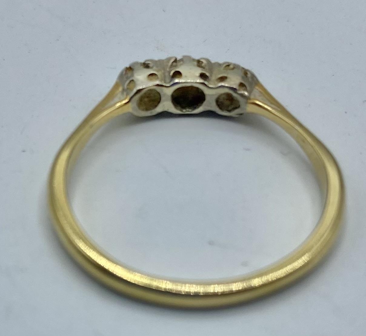An 18ct gold and diamond three stone ring. 2.26g. Size O. - Image 3 of 3