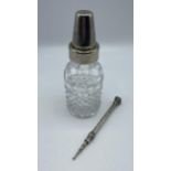 A cut glass and white metal baby bottle together with a white metal propelling pencil with