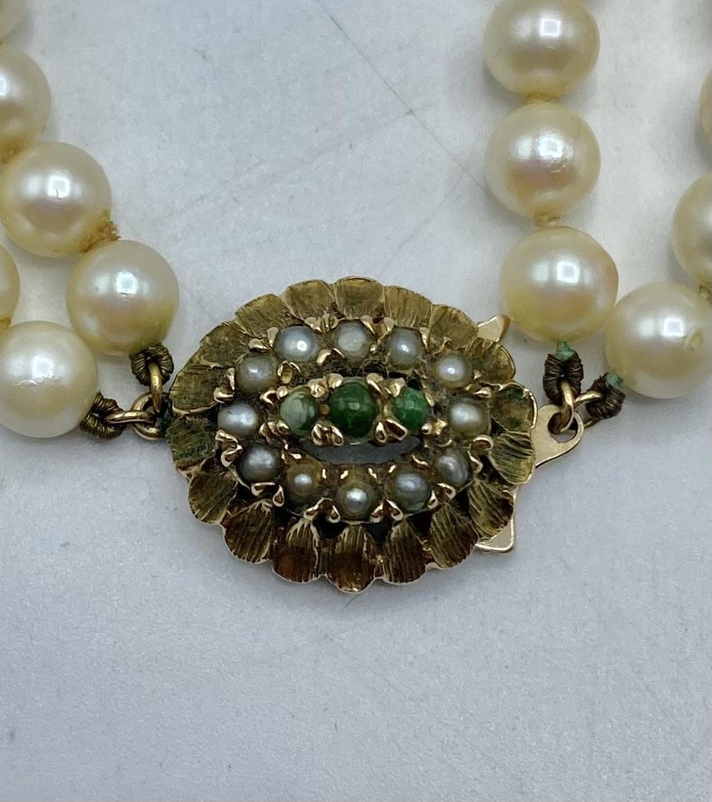 A double strand of graduated cultured pearls on a pearl set 9ct gold clasp. 48cm. - Image 2 of 3