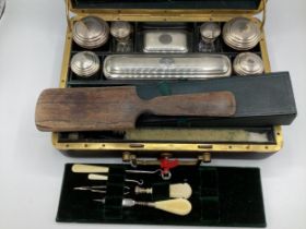 A ladies travelling vanity set marked Paris M-G to lock, near complete with original white metal