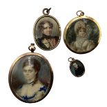 A collection of four yellow metal mounted miniature picture lockets , the largest indistinctly