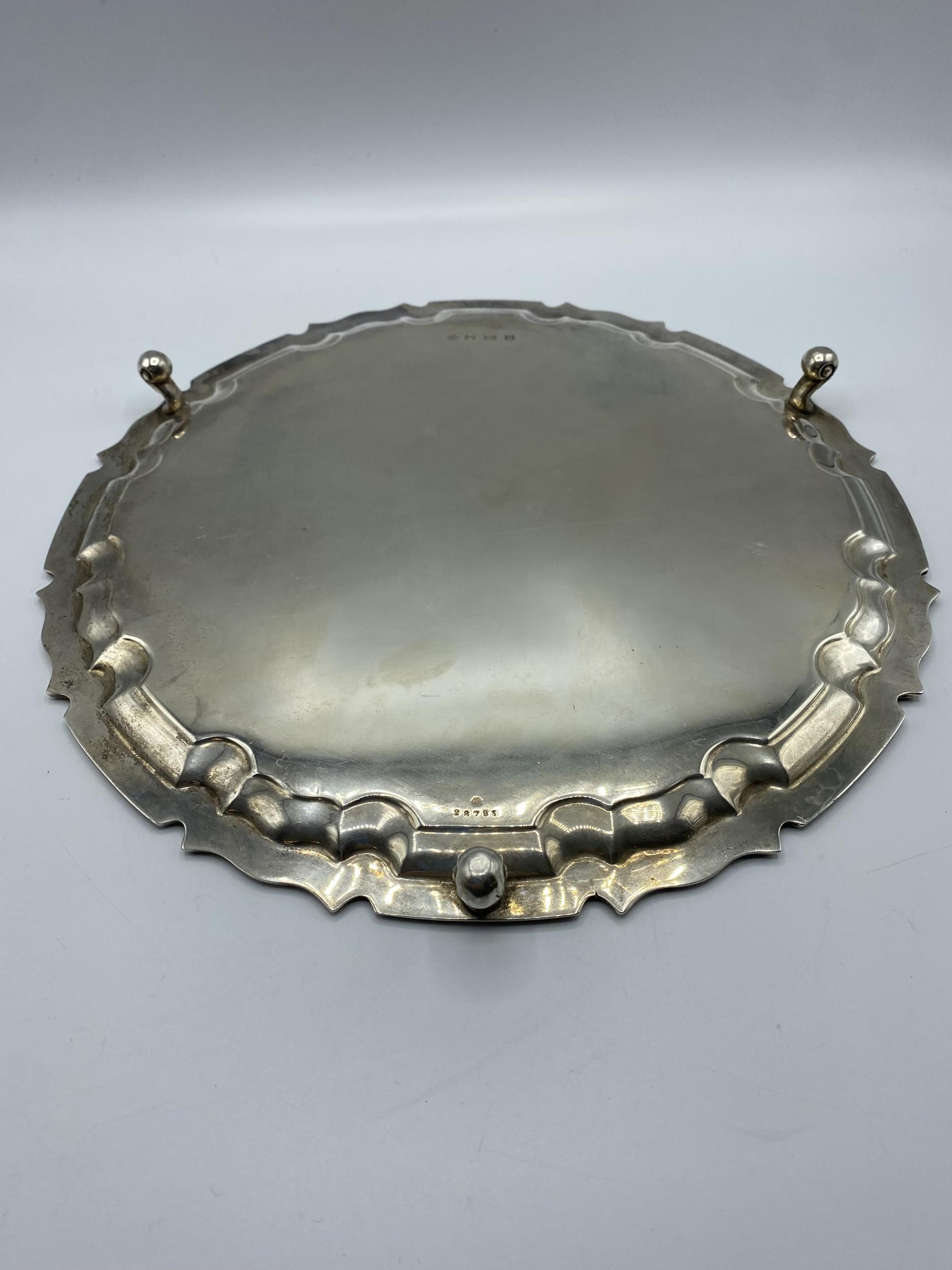 A sterling silver circular tray on three scroll feet by William Hutton and Sons Ltd, Sheffield 1922. - Image 3 of 10