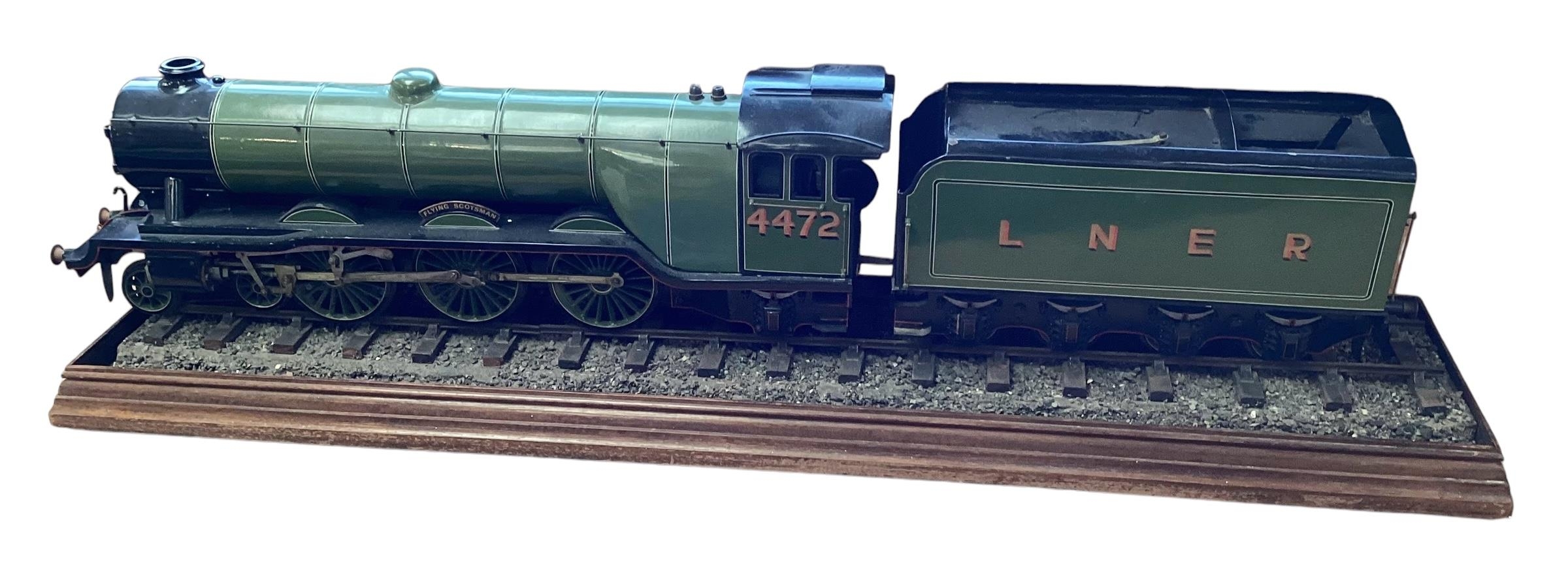 A large Desk top model of The Flying Scotsman Train. 4472 on a naturalistic track base with matching