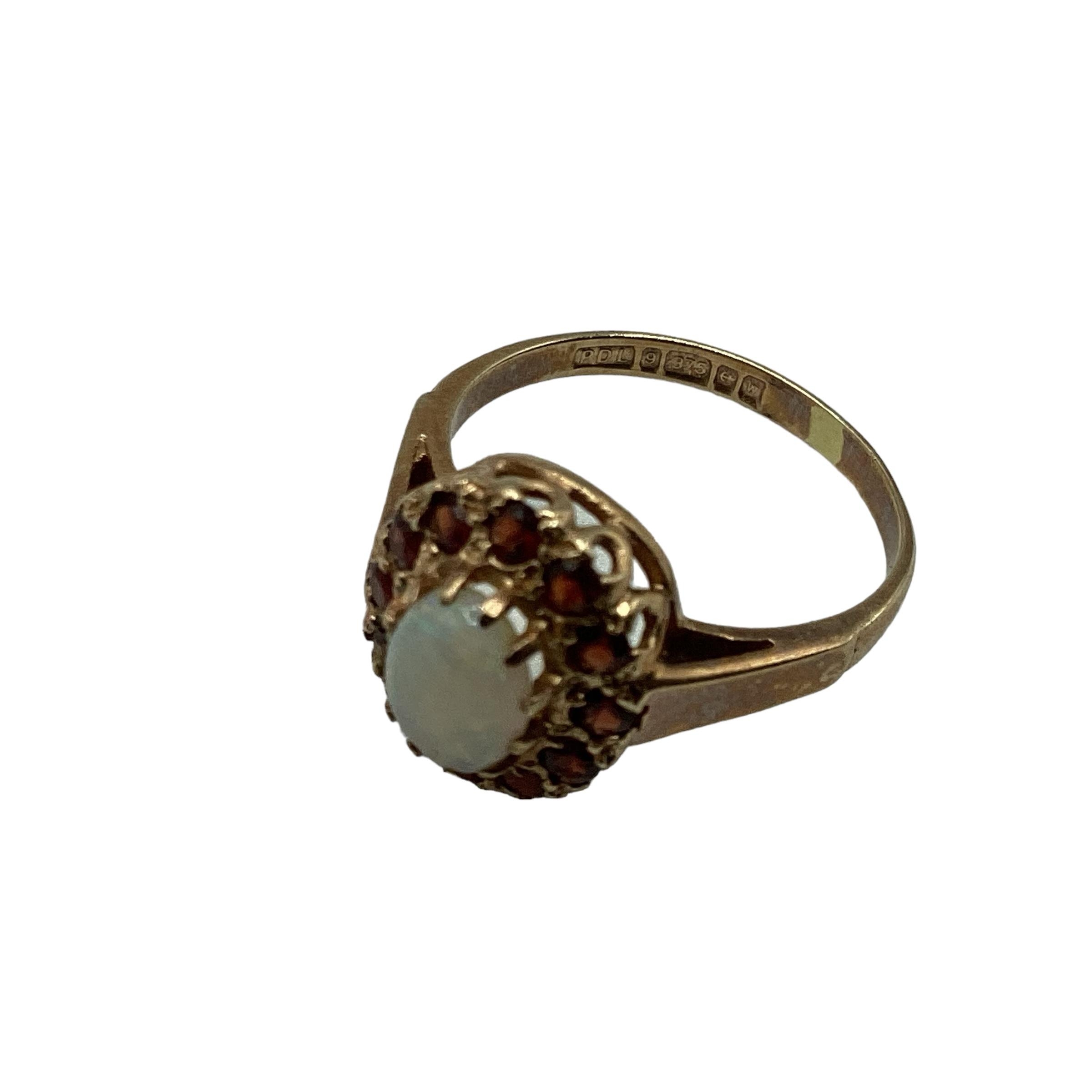 9 ct gold opal and garnet ring central oval opal with a surround of single cut red garnets size K, - Image 5 of 5