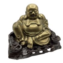 A large bronze seated Buddha on a carved hard wood stand. 23cm (h) including stand.