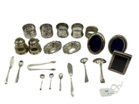 A collection of sterling silver items to include napkin rings , picture frames condiments etc. Gross