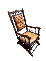 A buttoned back leather upholstered American style rocking chair