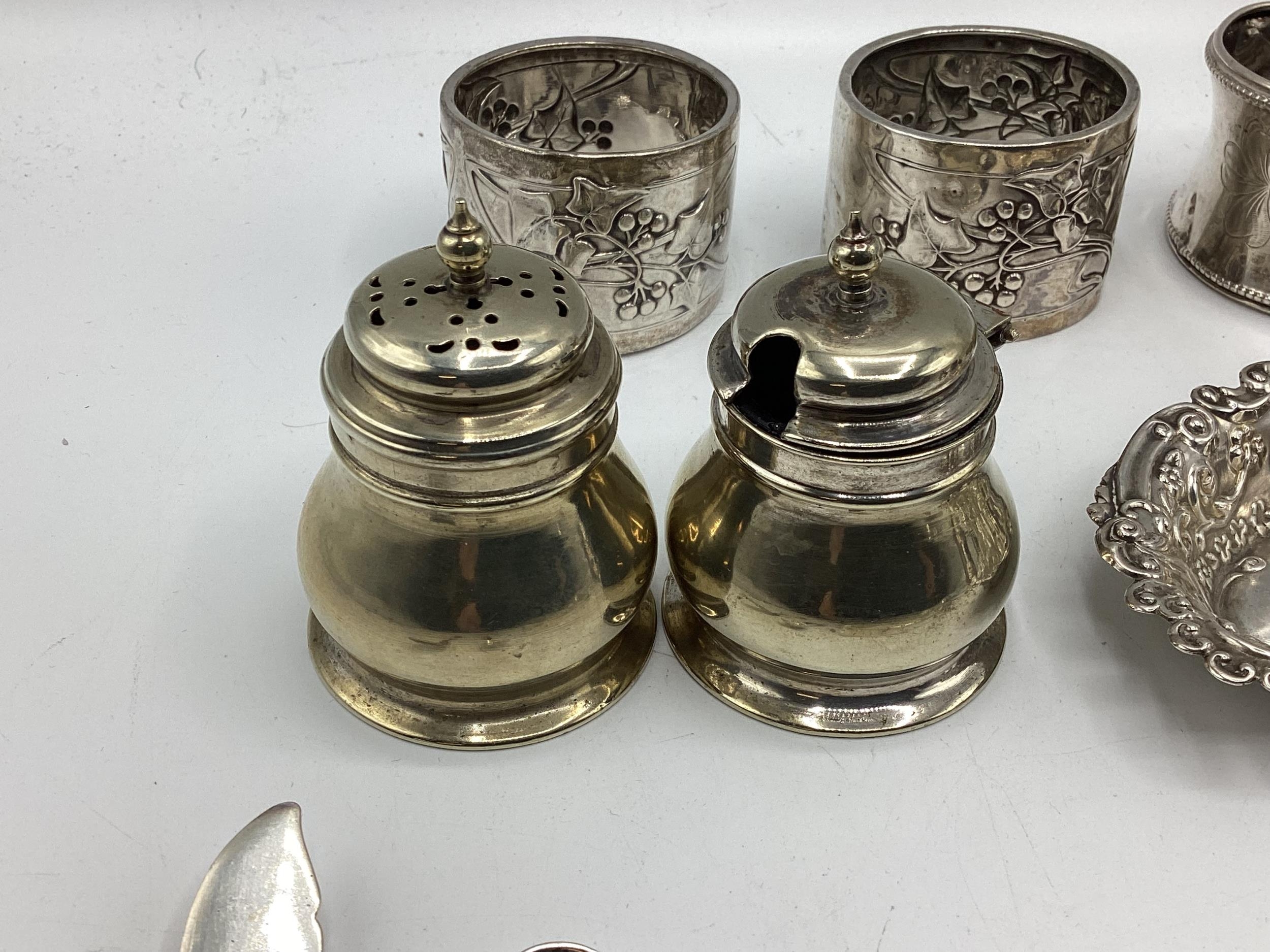 A collection of sterling silver items to include napkin rings , picture frames condiments etc. Gross - Image 8 of 15