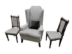 A very large high backed winged chair, 128 cm H upholstered in black and white stripes and a