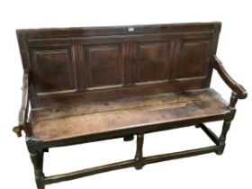 A part C18th and later, oak four panelled settle, 150cm W x 101cmH x 48cm D approx; some all over