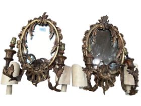 A pair of oval sconces, with mirrored back and ornate floral carved gesso surround, 39cm High