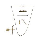 A collection of 9ct gold items , crucifix, ingot pendant and chain, pin brooch, together with a 10ct